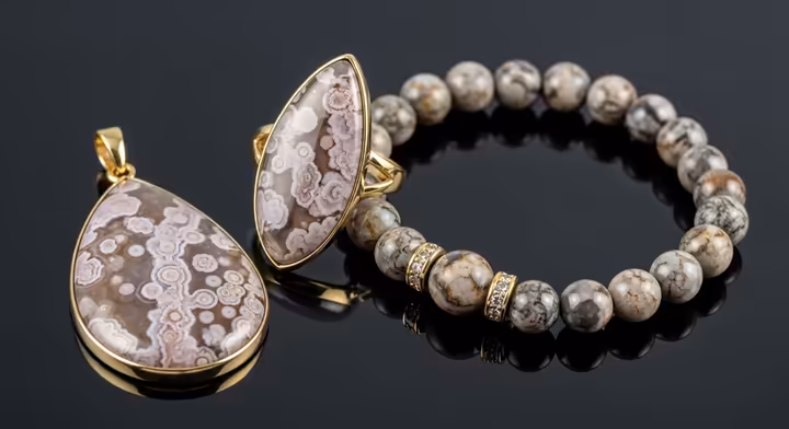 A collection of jewelry made from Crazy Lace Agate, including a pendant and a bracelet, highlighting the stone's durability and beauty.